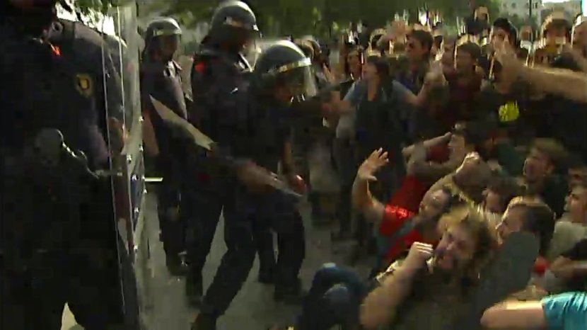 Agentes de los Mossos golpeando a personas concentradas en la plaza de Cataluña, en mayo de 2011
