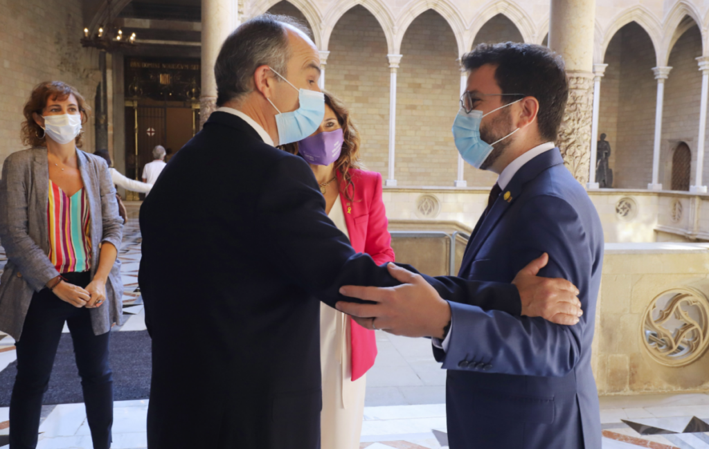 El presidente Pere Aragonès, saludando al exconsejero Jordi Turull