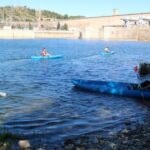 Participantes en la Marcha de los Sedimentos entrando en el río Ebro con kayaks para bajar hasta Flix desde el pantano de Riba-roja d'Ebre (Anna Ferràs, ACN)