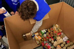 Un voluntari col·loca els aliments recollits (ACN)
